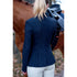 Person wearing a navy equestrian jacket standing next to a horse.